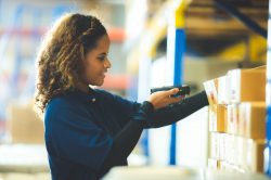 warehouse worker using bar code scanner to analyze newly arrived goods for further placement in storage department, Working at warehouse. warehouse worker using bar code scanner to analyze newly arrived goods for further placement in storage department, Working at warehouse.